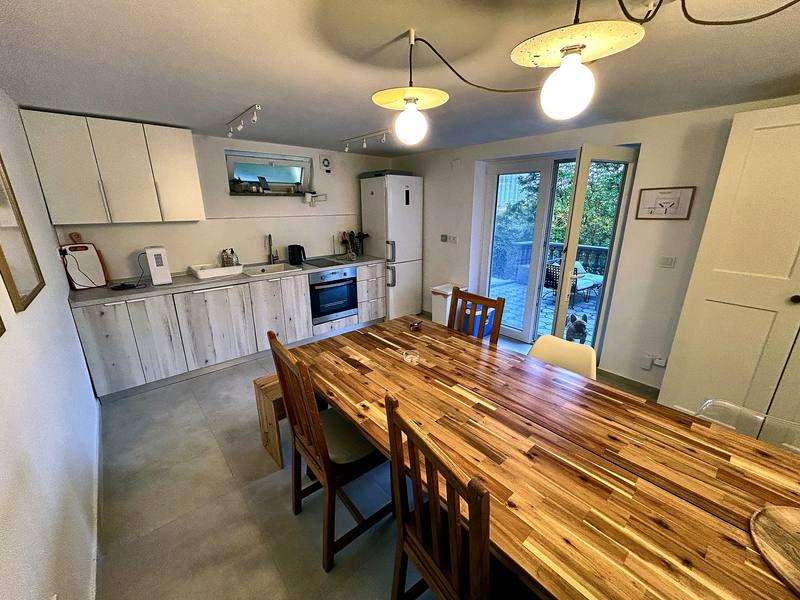 Kitchen and dining area with a long wooden table